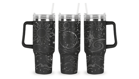 Engraved tumbler with celestial design featuring stars, moons, and planets.