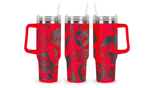 Stainless steel tumbler with an engraved wolf design, featuring a howling wolf and moon details.